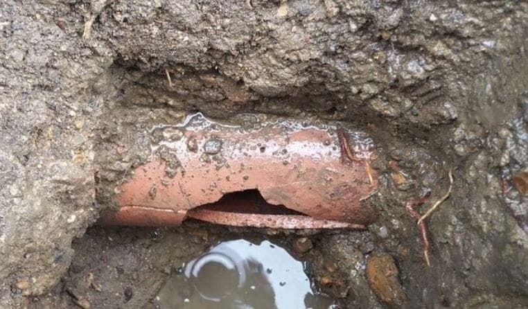 Collapsed stormwater drain pipe in Sydney showing complete pipe failure requiring emergency pipe relining or replacement