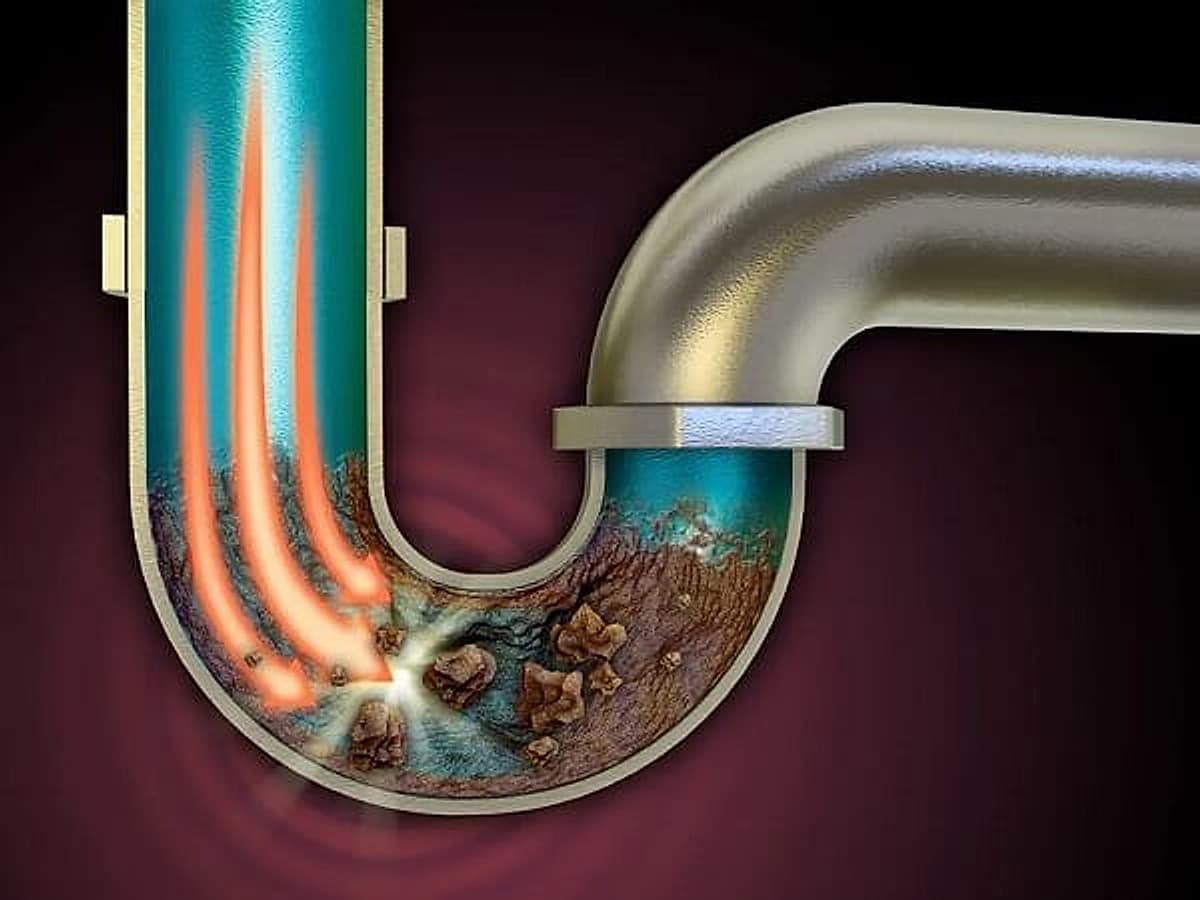 Illustration of a blocked drain caused by buildup and pipe damage