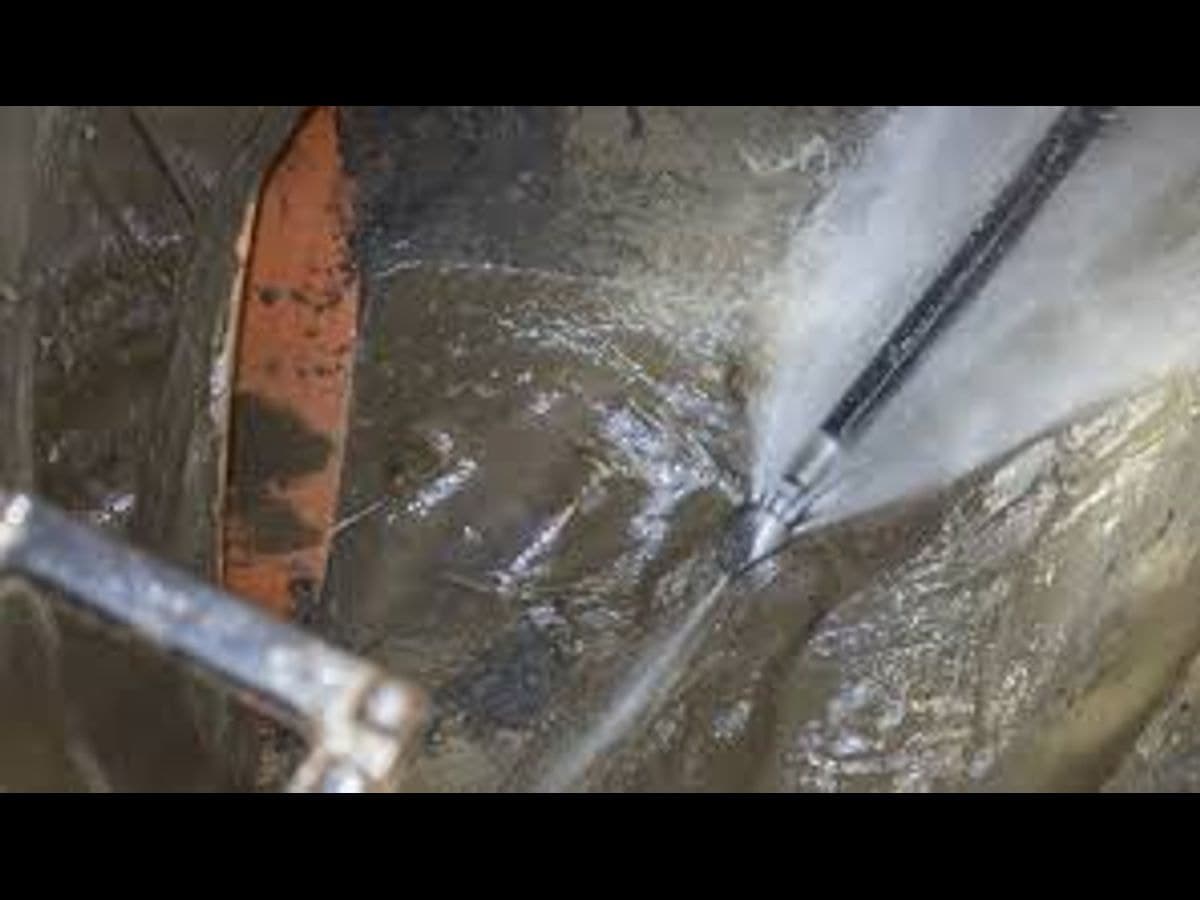 Drain cleaning nozzle blasting water through a pipe
